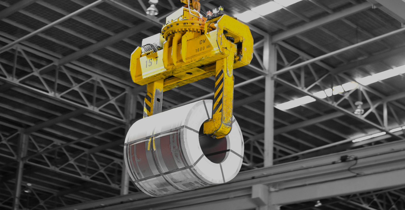 Coil tong lifting steel coils in industrial material handling operation banner